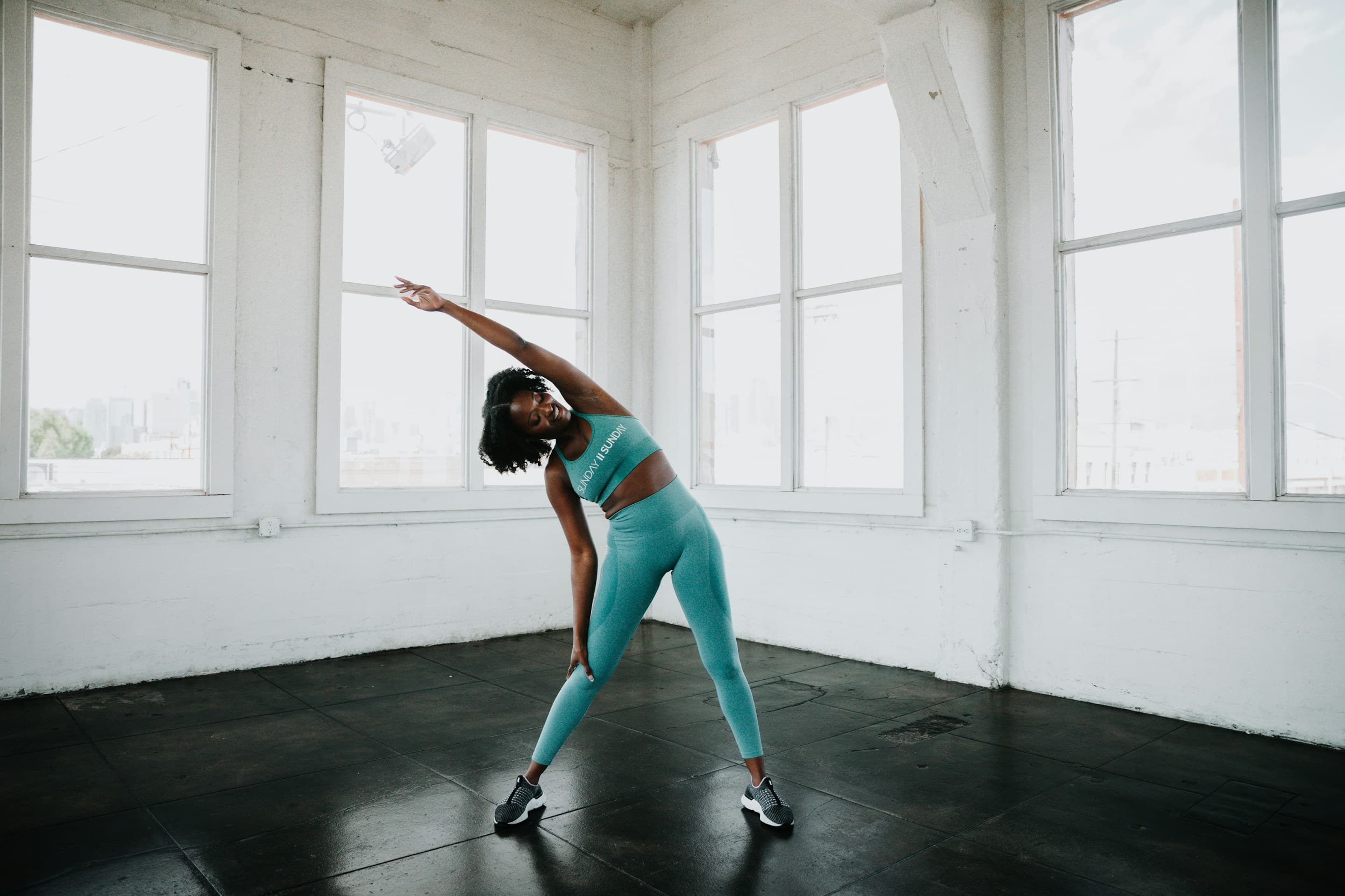 Woman stretching in a bright studio